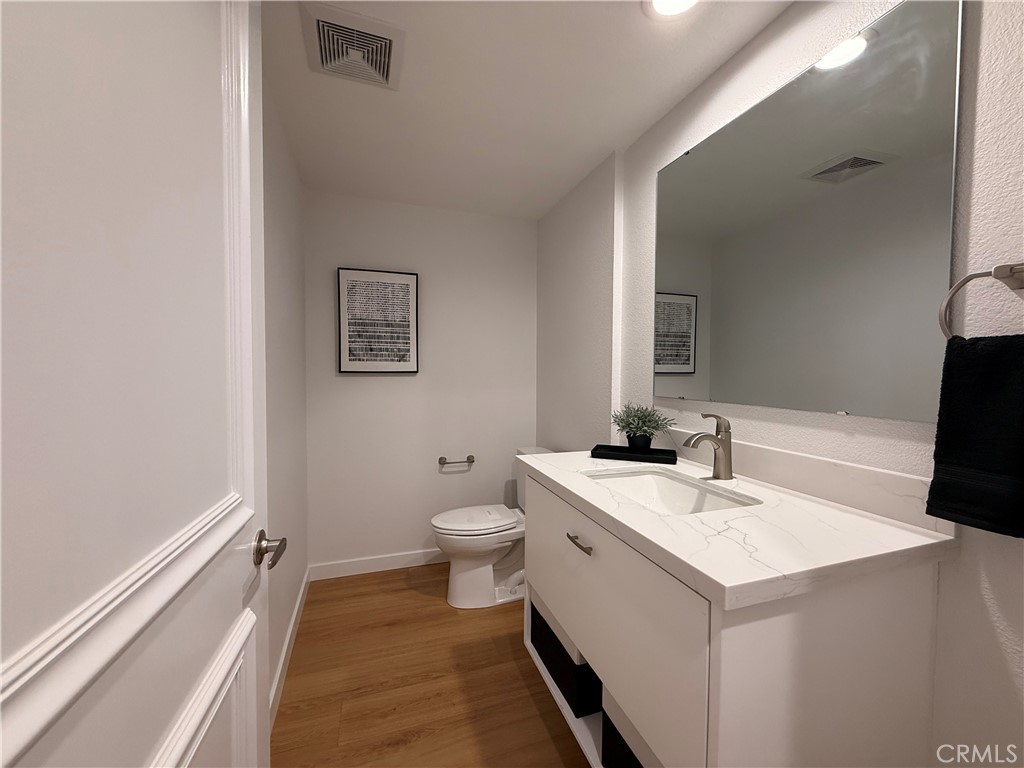 1921 St John Road, Unit 35C Seal Beach, CA 90740 - Photo 18 of 40 a bathroom with a sink a toilet and a mirror