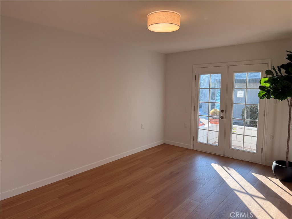 1921 St John Road, Unit 35C Seal Beach, CA 90740 - Photo 33 of 40 a view of an empty room with a window and wooden floor