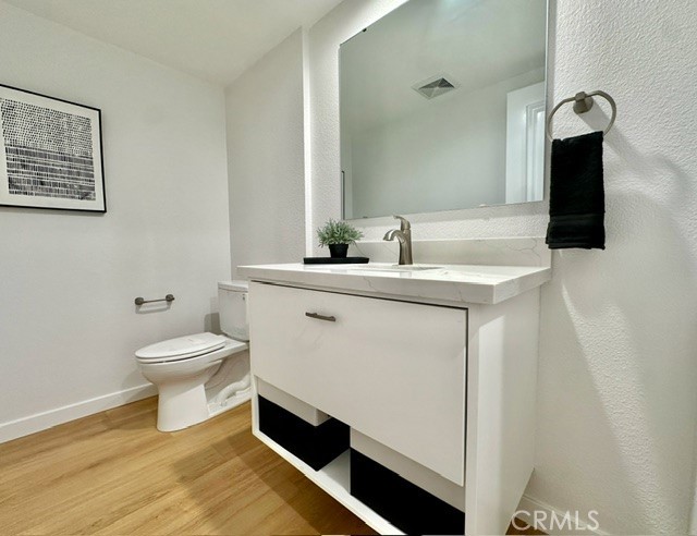 1921 St John Road, Unit 35C Seal Beach, CA 90740 - Photo 9 of 11 a bathroom with a toilet a sink and mirror