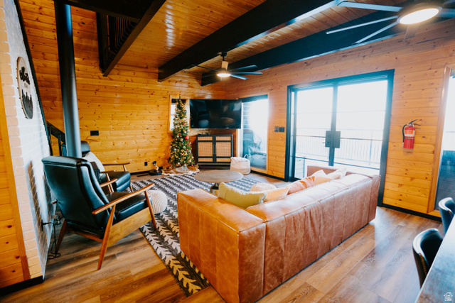 1413 Basel Drive Midway, UT 84049 - Photo 10 of 137 Living area featuring wood walls, a ceiling fan, wood finished floors, and a wooden ceiling with exposed beams