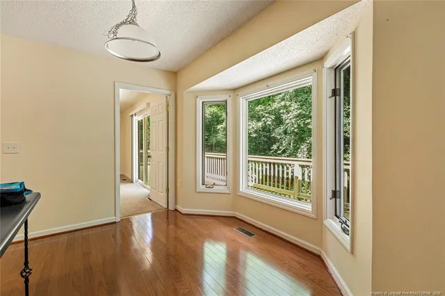 a view of a room with wooden floor and windows