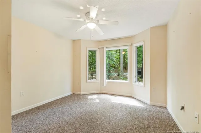 an empty room with windows and closet