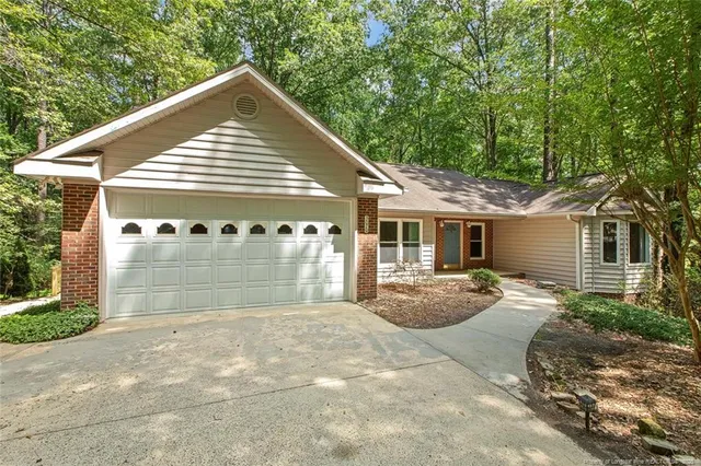 a view of a house with a yard and sitting area