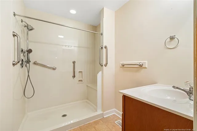 a bathroom with a sink a mirror and a shower