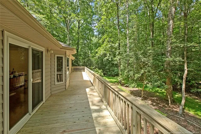 a view of a wooden deck and a yard