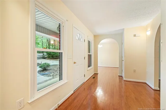 a view of hallway with wooden floor