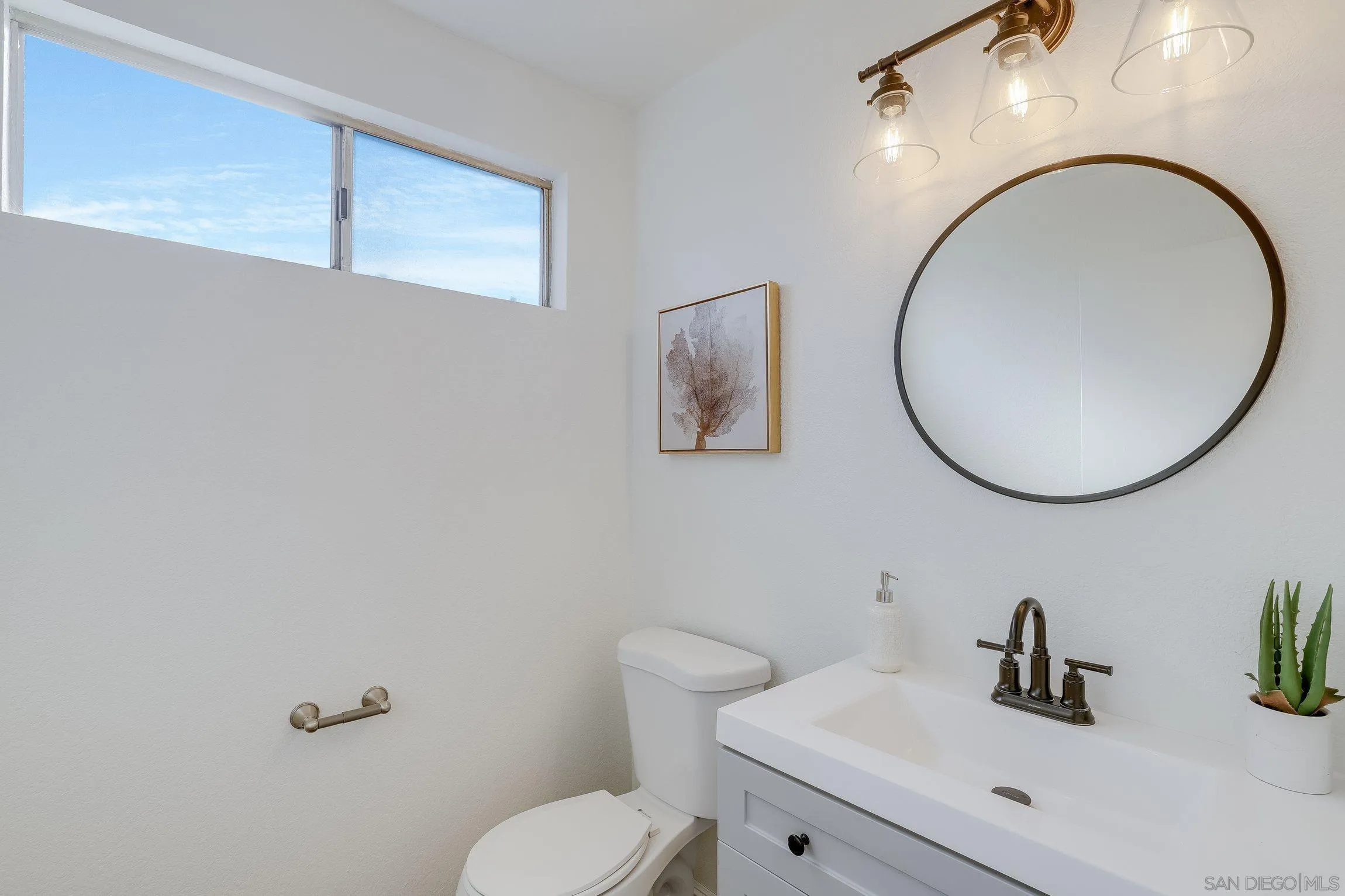 2305 Peppermint Lane Lemon Grove, CA 91945 - Photo 11 of 25 a bathroom with a toilet a sink and mirror