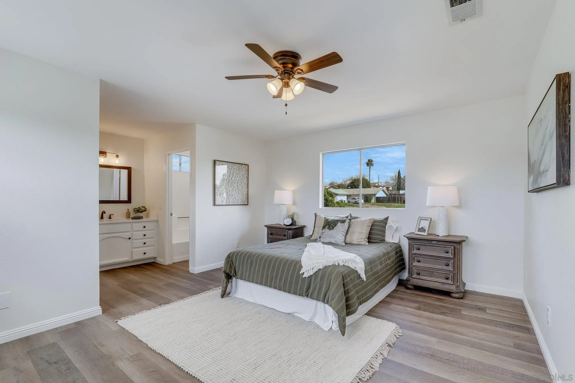 2305 Peppermint Lane Lemon Grove, CA 91945 - Photo 13 of 25 a bedroom with a bed and a chandelier