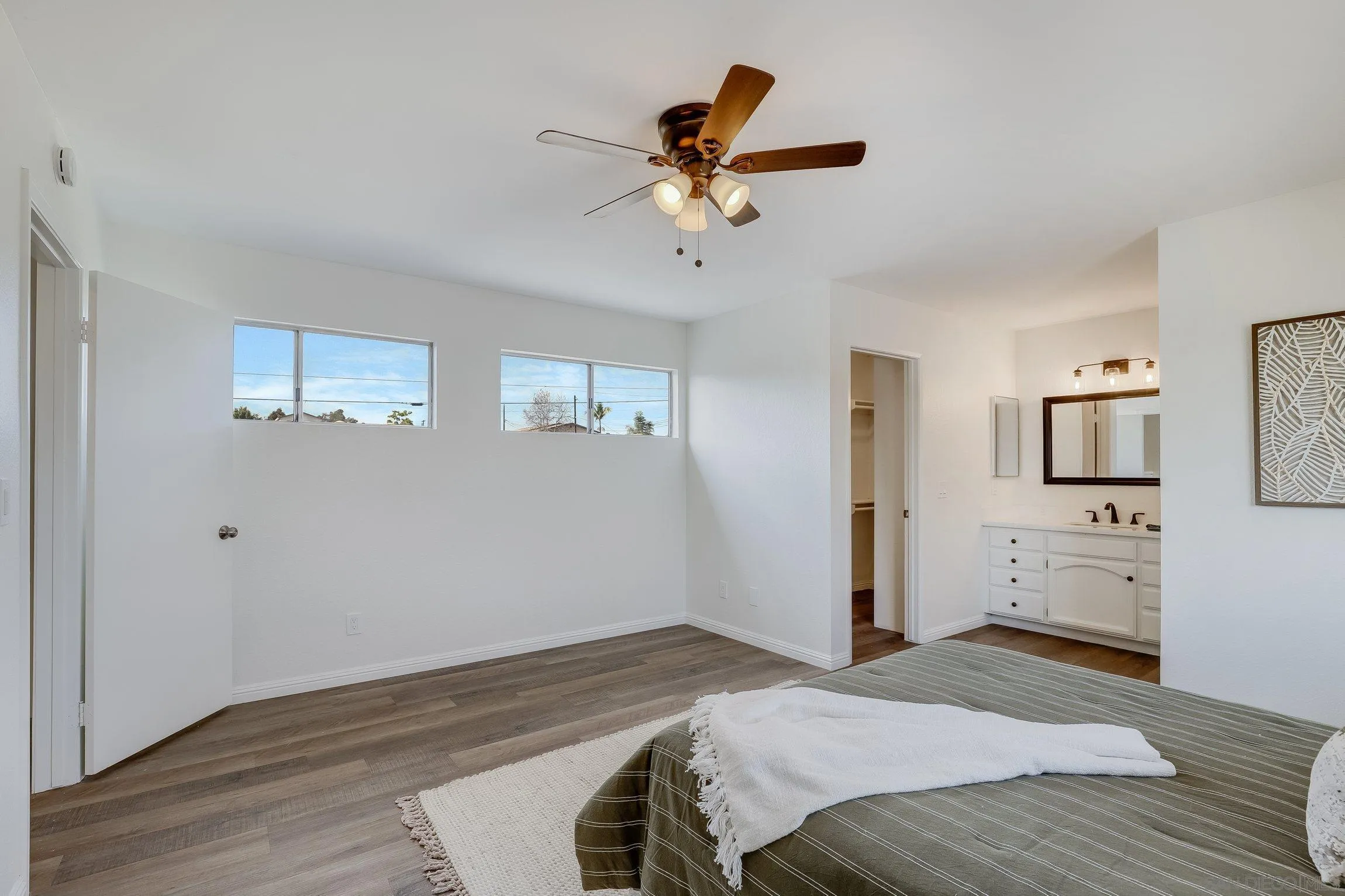 2305 Peppermint Lane Lemon Grove, CA 91945 - Photo 14 of 25 a bedroom with a bed and a chandelier