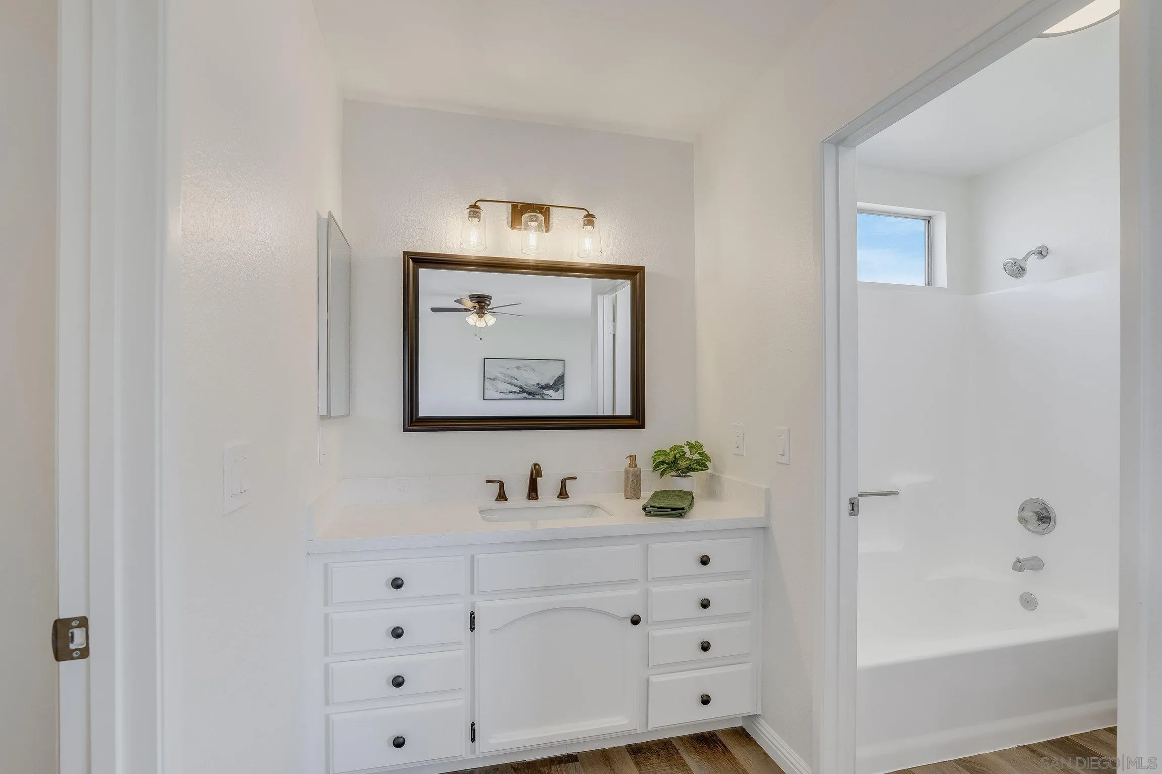 2305 Peppermint Lane Lemon Grove, CA 91945 - Photo 15 of 25 a bathroom with a granite countertop sink and a mirror