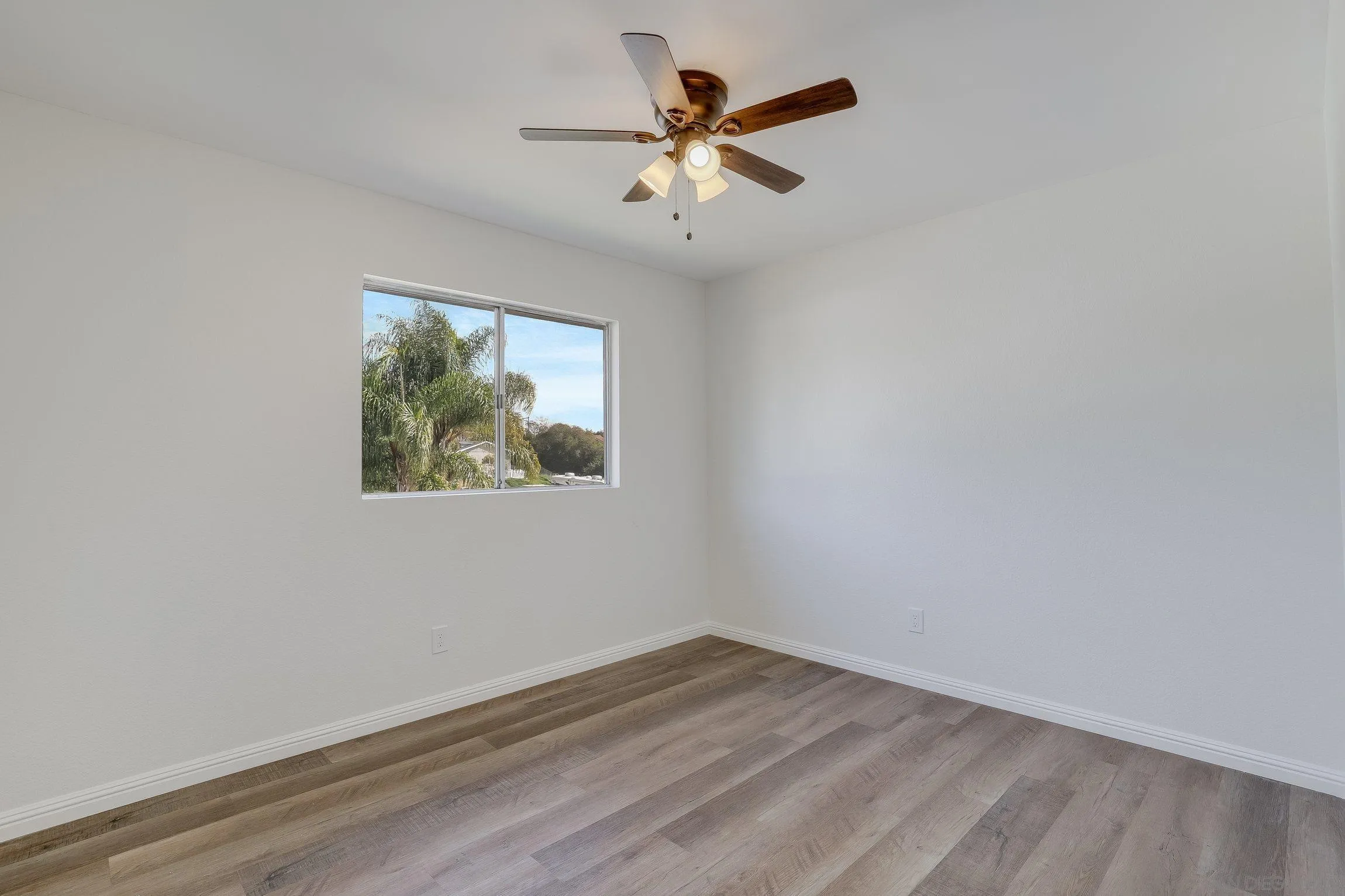 2305 Peppermint Lane Lemon Grove, CA 91945 - Photo 18 of 25 an empty room with a window and a ceiling fan