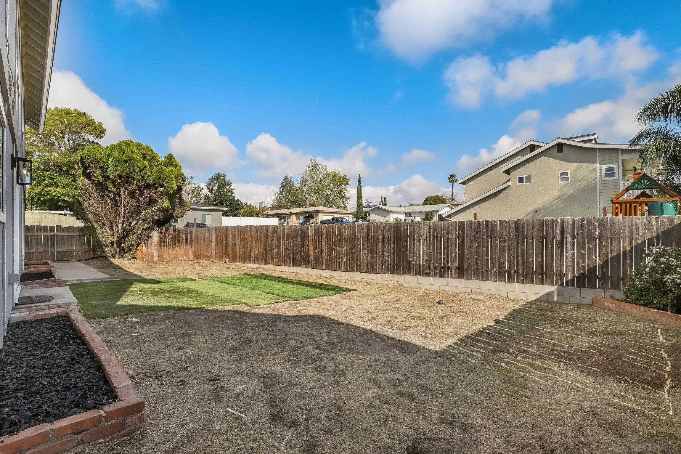 2305 Peppermint Lane Lemon Grove, CA 91945 - Photo 22 of 25 a backyard of a house with a yard and outdoor seating