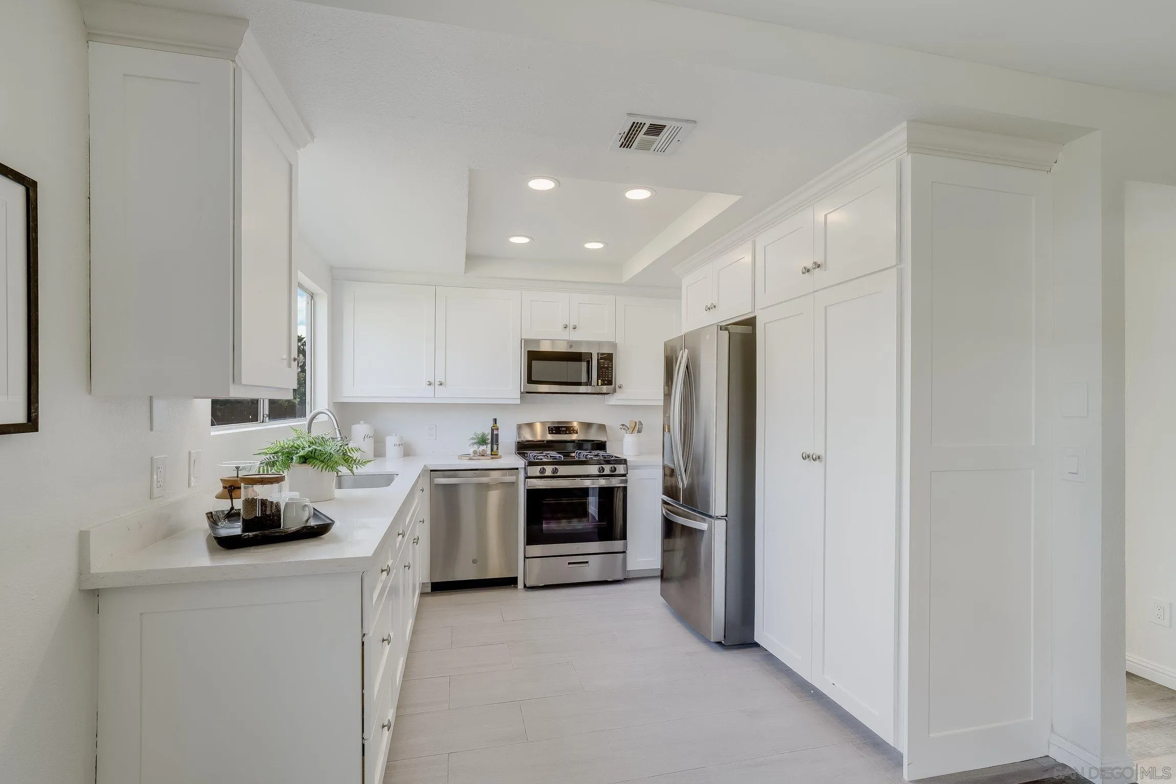 2305 Peppermint Lane Lemon Grove, CA 91945 - Photo 7 of 25 a kitchen with cabinets and stainless steel appliances