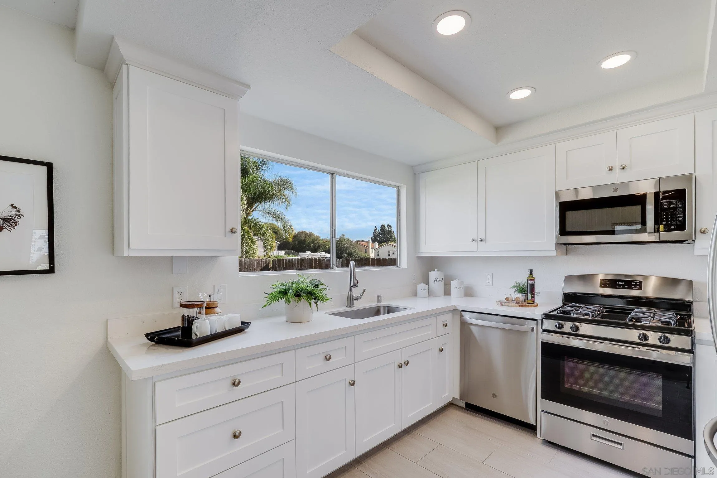 2305 Peppermint Lane Lemon Grove, CA 91945 - Photo 8 of 25 a kitchen with white cabinets and appliances