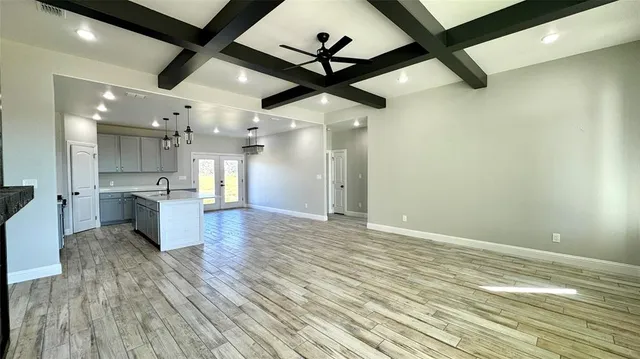 a view of a kitchen with a sink and wooden floor
