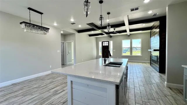 a kitchen with stainless steel appliances kitchen island a large island in the center and wooden floor