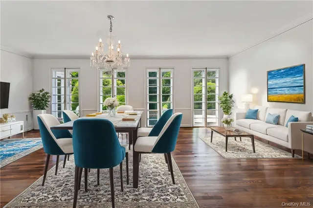 a view of a dining room with furniture a chandelier and wooden floor