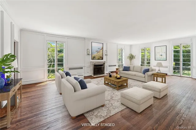 a living room with fireplace furniture and a wooden floor