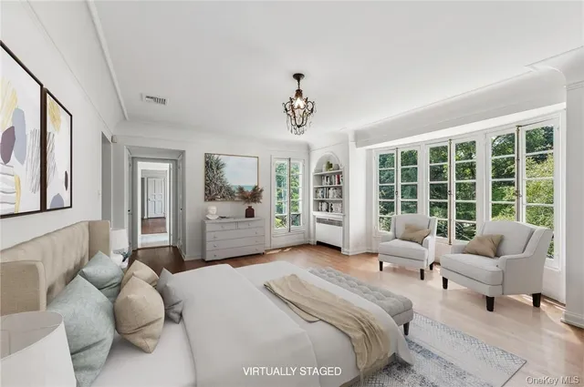 a spacious bedroom with a bed couch and a large window