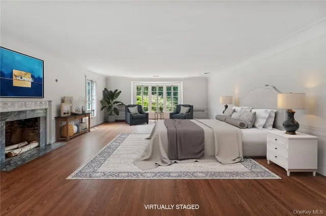 a large bedroom with a bed and a fireplace