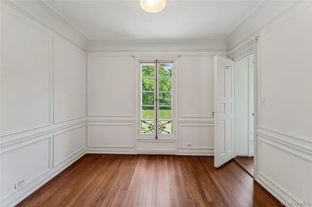 a view of a room with wooden floors and window