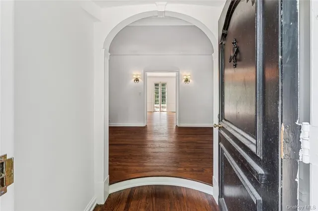 a view of a hallway with wooden floor