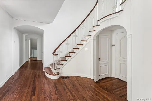 a view of entryway with wooden floor and stairs