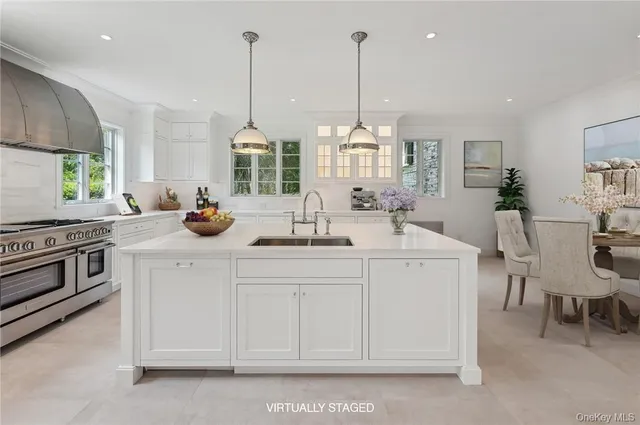 a kitchen with stainless steel appliances a sink stove and window