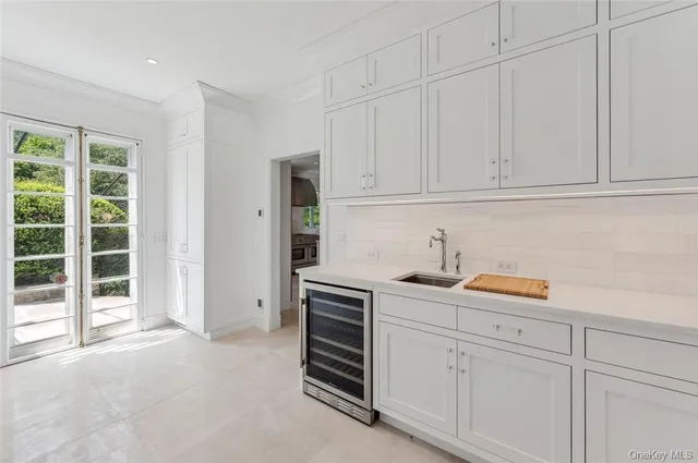 a kitchen with stainless steel appliances granite countertop a sink and cabinets with wooden floor