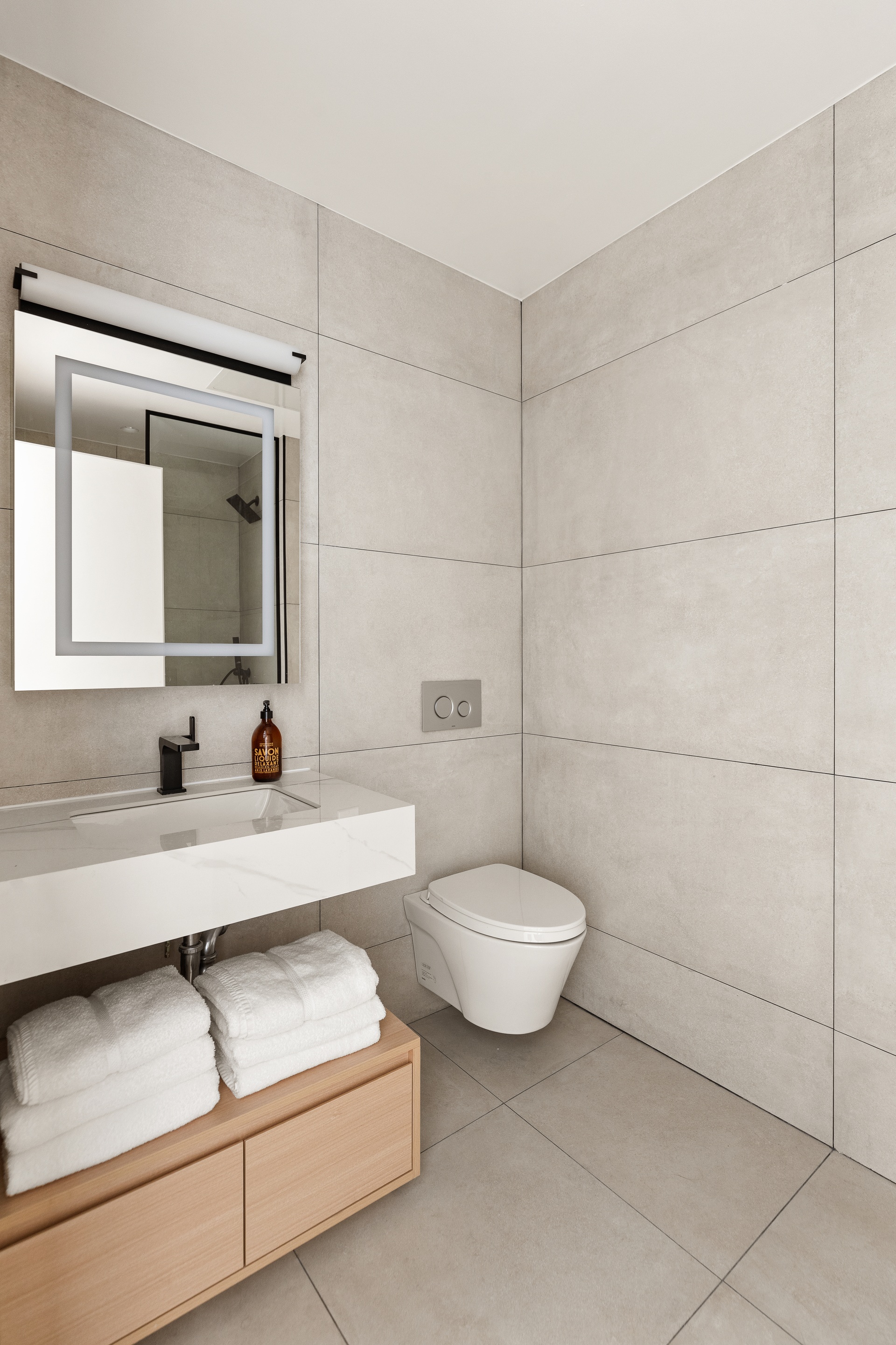 179 20th Street, Unit 4A Brooklyn, NY 11232 - Photo 8 of 12 a bathroom with a toilet a sink and mirror