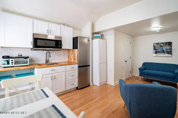 a kitchen with a refrigerator and a sink