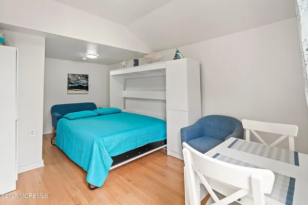 a bedroom with a bed and a chair