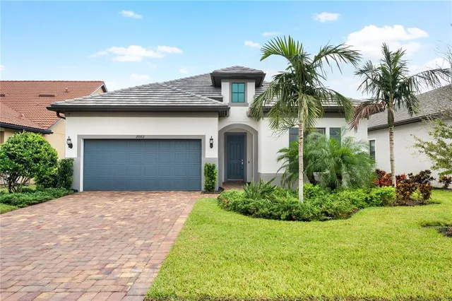 a front view of a house with a yard and garage