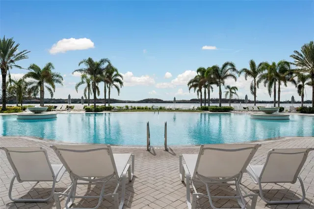 a view of a swimming pool with a patio and a garden