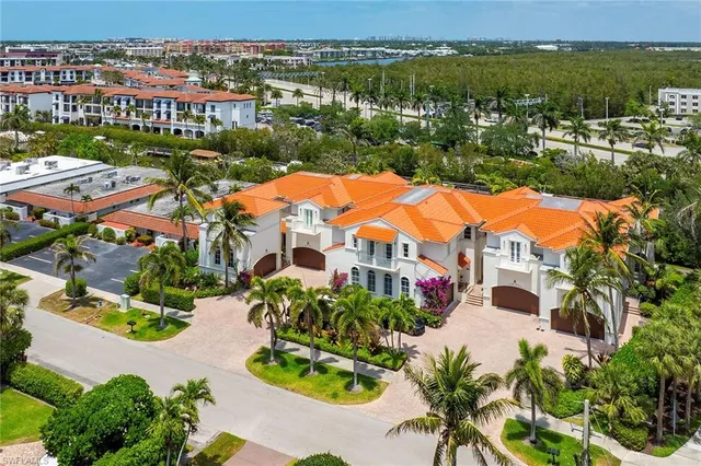an aerial view of residential houses with outdoor space and swimming pool