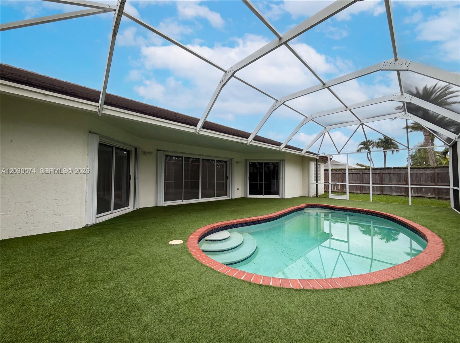 16571 Southwest 145th Avenue Miami, FL 33177 - Photo 5 of 25 a view of a swimming pool with a patio