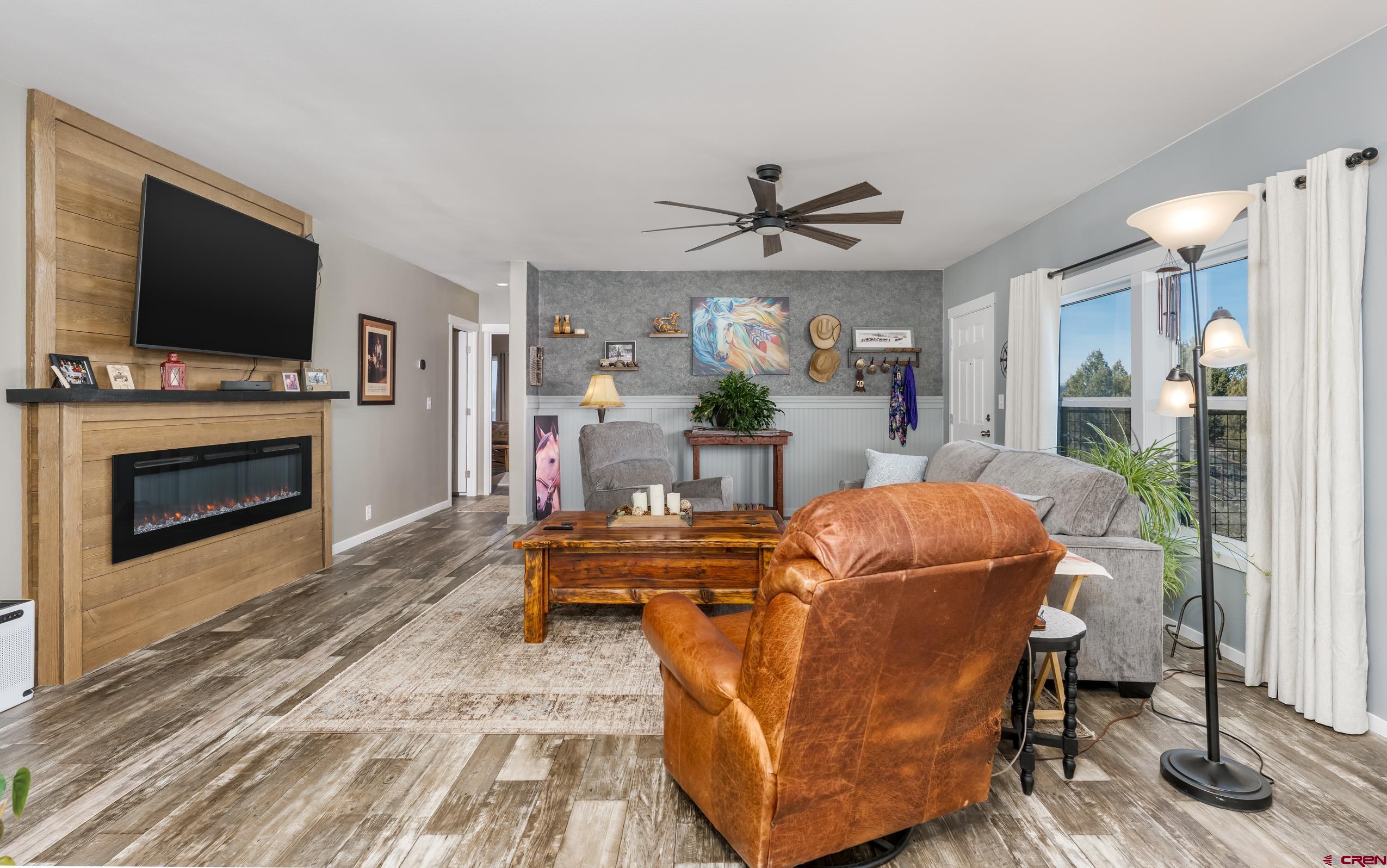 5102 County Road 311 Ignacio, CO 81137 - Photo 12 of 36 a living room with furniture a flat screen tv and a fireplace