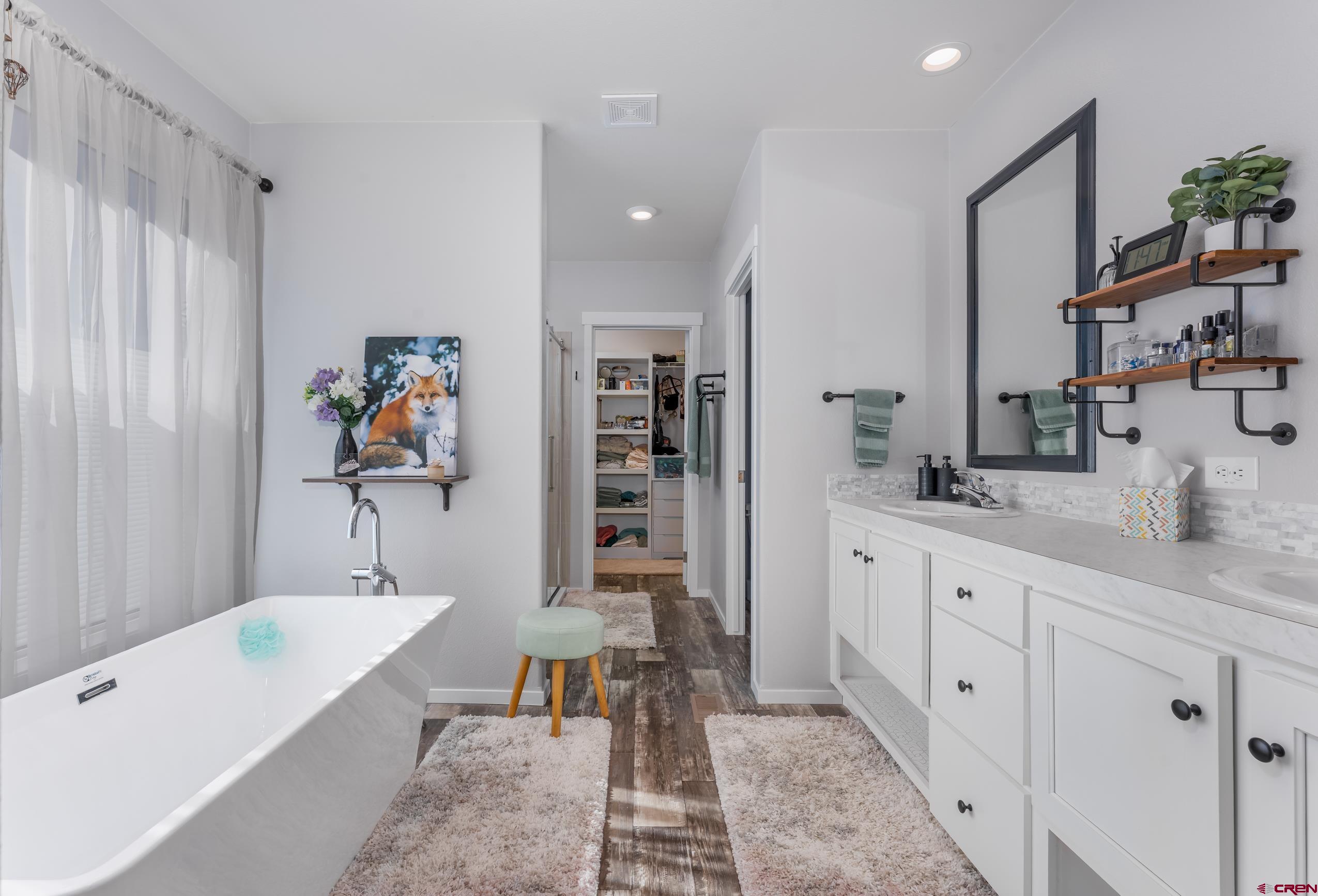 5102 County Road 311 Ignacio, CO 81137 - Photo 15 of 36 a spacious bathroom with a tub sink and mirror