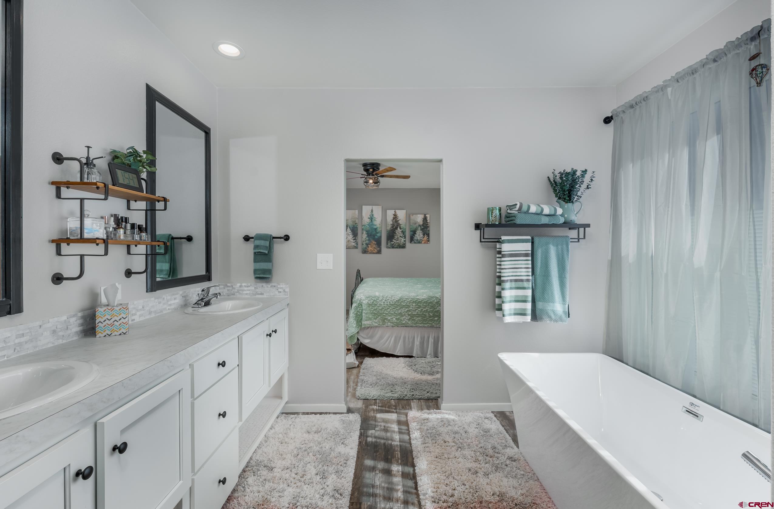 5102 County Road 311 Ignacio, CO 81137 - Photo 19 of 36 a spacious bathroom with a granite countertop sink and a mirror
