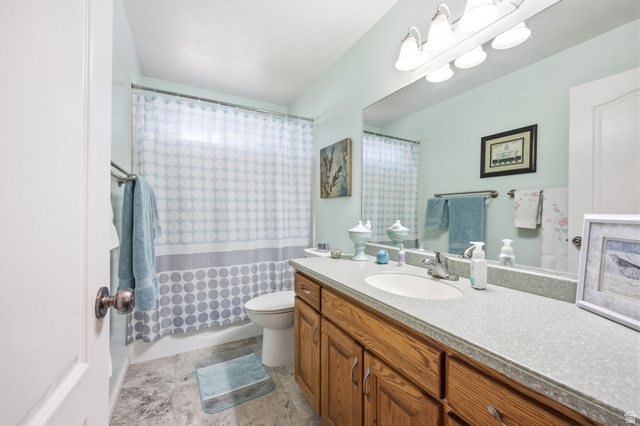 776 Flint Street Layton, UT 84041 - Photo 17 of 41 Bathroom featuring a wood-finish vanity with a single sink and light-colored countertop