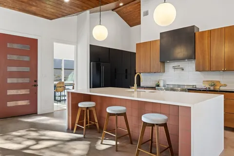 a kitchen with stainless steel appliances granite countertop a sink and a refrigerator