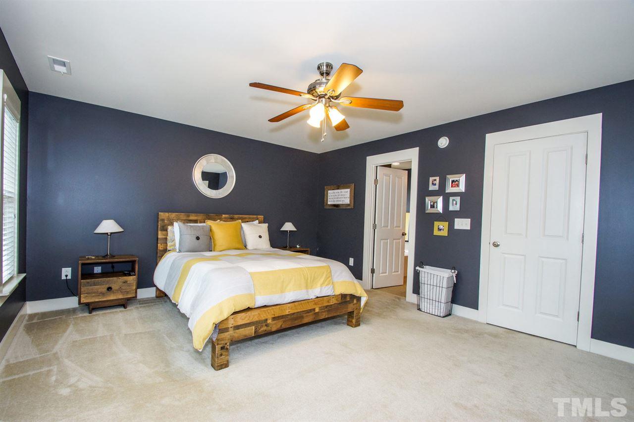 2244 Dunlin Lane Raleigh, NC 27614 - Photo 11 of 23 a bedroom with a bed and a chandelier