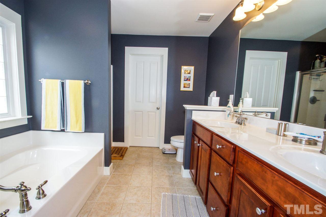 2244 Dunlin Lane Raleigh, NC 27614 - Photo 12 of 23 a spacious bathroom with a tub sink and mirror