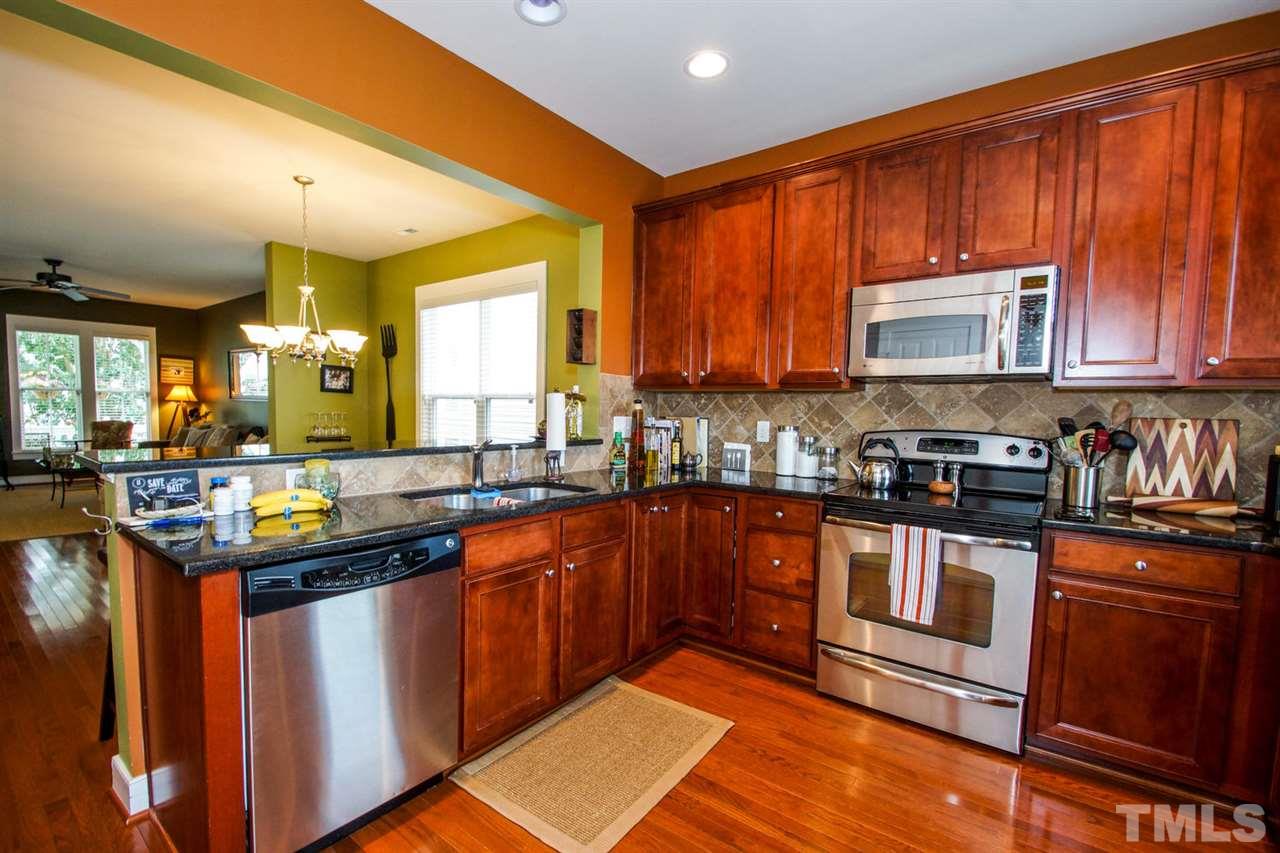 2244 Dunlin Lane Raleigh, NC 27614 - Photo 8 of 23 a kitchen with stainless steel appliances granite countertop a stove a sink dishwasher and a microwave oven with cabinets