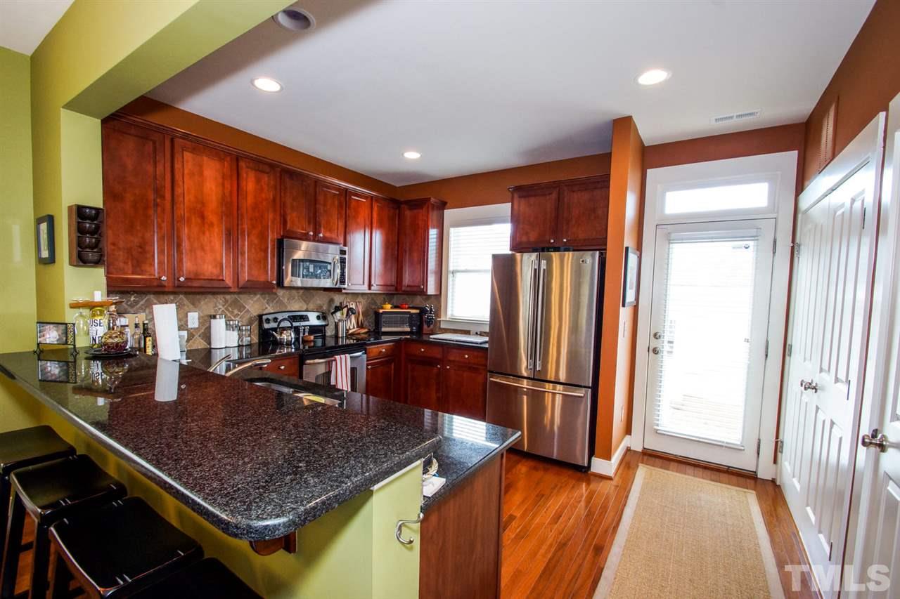 2244 Dunlin Lane Raleigh, NC 27614 - Photo 9 of 23 a kitchen with stainless steel appliances granite countertop a refrigerator a stove top oven a sink and dishwasher