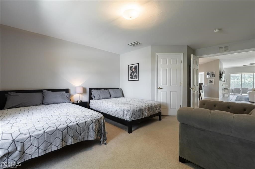 10074 Oakhurst Way Fort Myers, FL 33913 - Photo 11 of 32 a bedroom with a bed and a couch