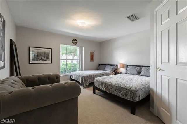 a bedroom with two beds and a window