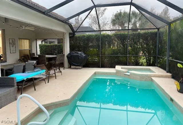 a swimming pool with outdoor seating and yard