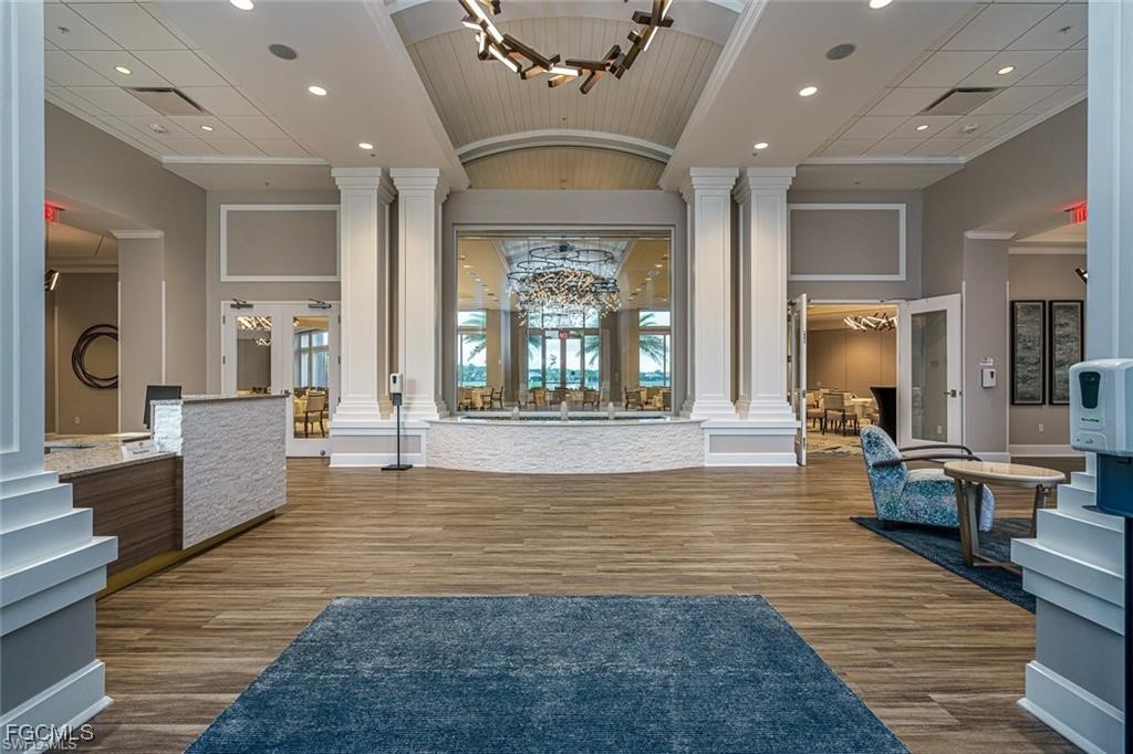 10074 Oakhurst Way Fort Myers, FL 33913 - Photo 27 of 32 a living room with furniture large window and wooden floor