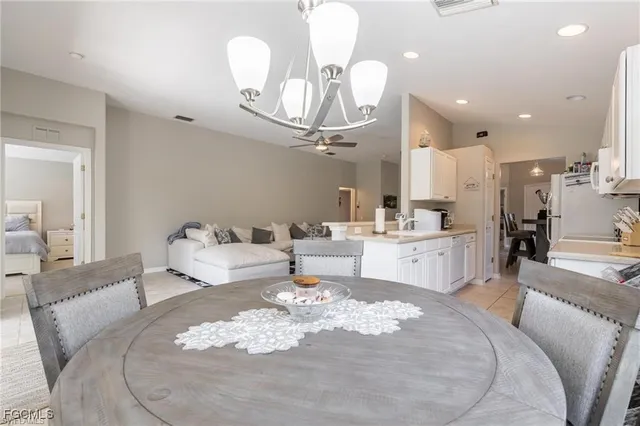 a living room with kitchen island furniture and a chandelier